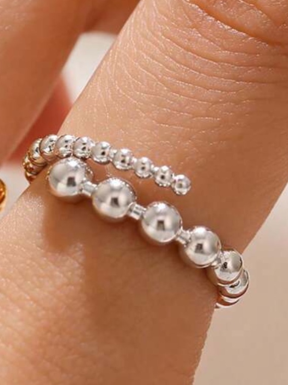 New in Package Silver tone bead ring adjustable Size 7. Italian style.